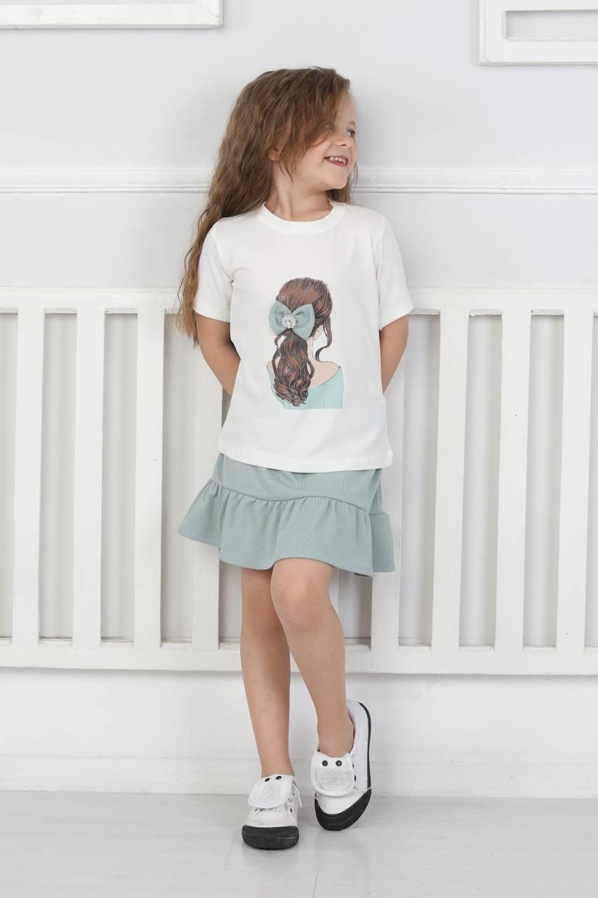 : Girl in T-shirt with pattern and skirt
